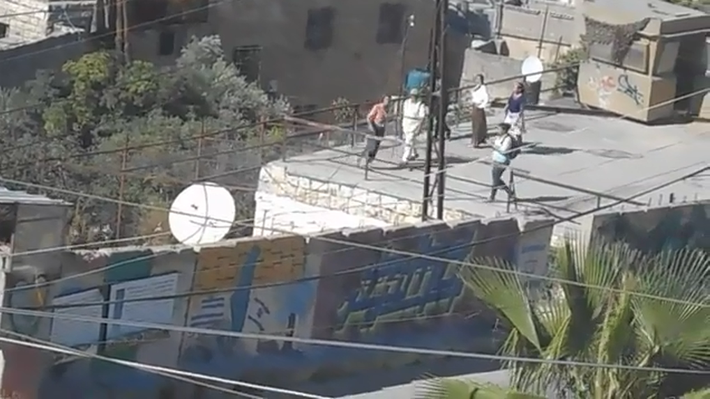 Video- Soldiers assault a twelve-year-old Palestinian while settlers invade family rooftop in Hebron