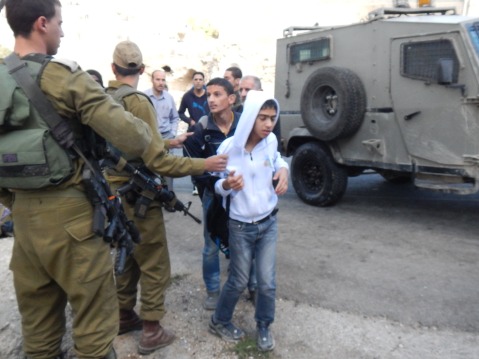 The children being detained by Israeli soldiers (photo by ISM).