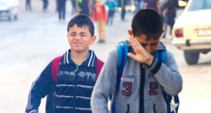 Two school children suffer from the effects of tear gas