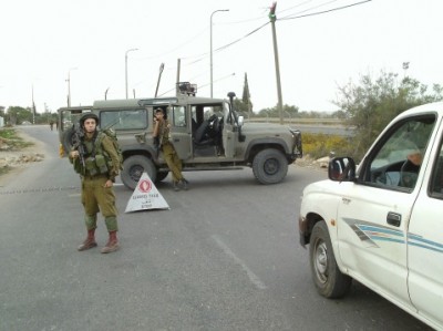 Israeli soldiers and the flying checkpoint outside the village
