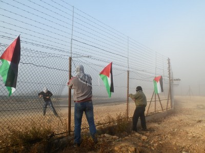 The fence is torn down by Palestinian activists (photo by ISM).