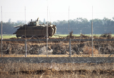 An Israeli military vehicle by the separation barrier near Khuza'a. (Photo by Silvia Todeschini)