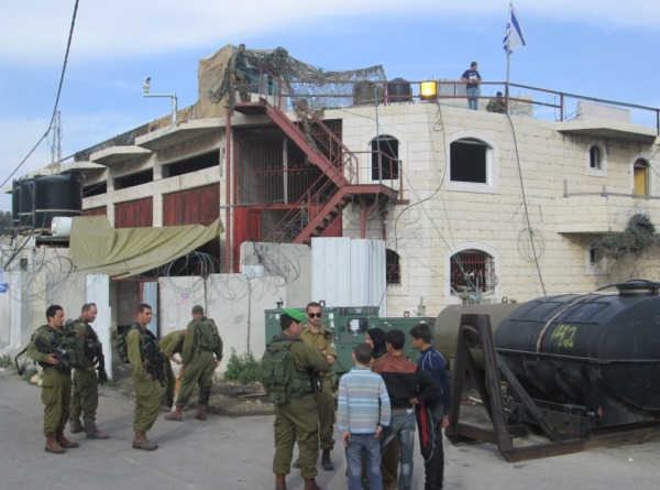 Settlers move into the Rajabi building in Hebron