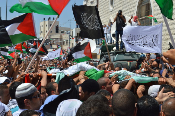 Palestinians protest the murder of Mohammed Abu Khdeir and destroy apartheid tramway