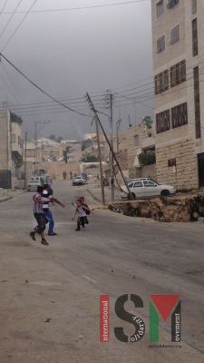Children running from the soldiers and the tear gas.