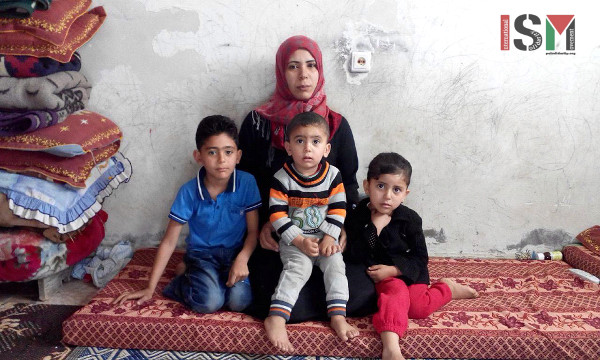 Mohamed’s wife with their three children.