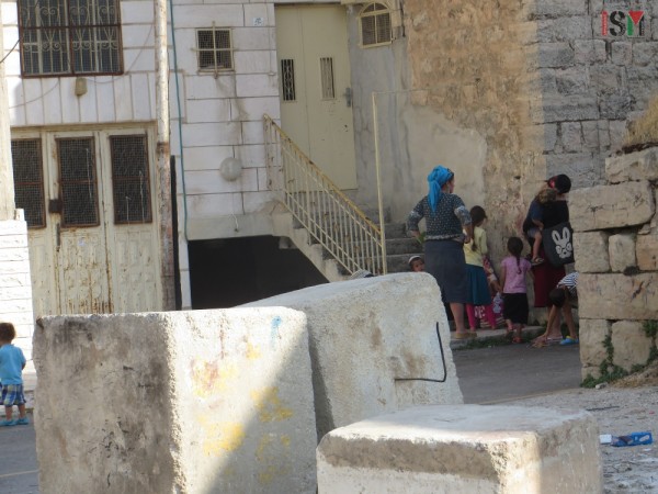 Settler women with their children blocking the stairs to the Abu Rajab house