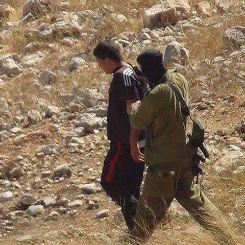 Israeli soldier arresting Mahmoud
