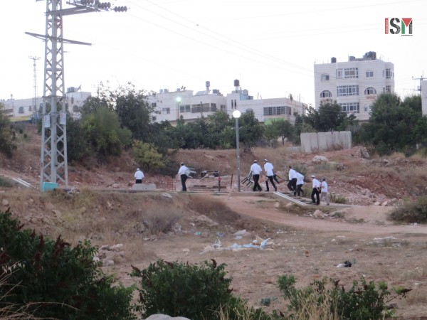 Settlers coming from the illegal settlement of Kiryat Arba onto Palestinian land for prayers