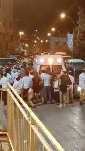 Ambulance carrying dying Palestinian prevented from leaving Shuhada Street by frenzied settlers. 