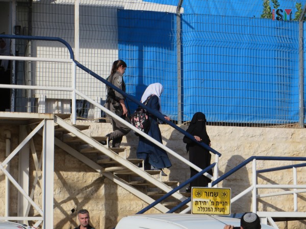 One of the girls walked to the police car by Israeli forces