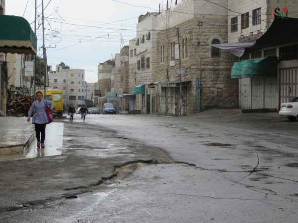 Palestinian schoolgirls running away from tear gas