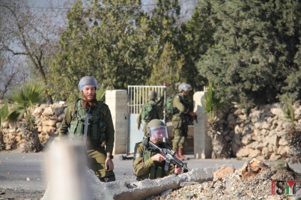 Soldiers preparing to shoot at protesters in the village of Silwad.