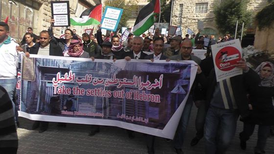 Demonstrators marching under the banner of 'take the settlers out of Hebron'