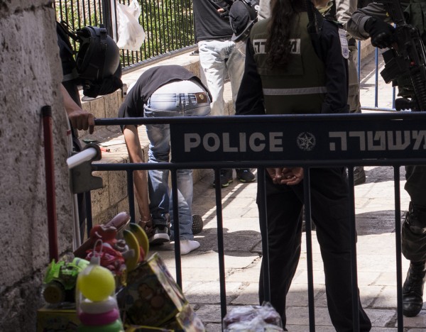 The body searches are harsh and humiliating. Young men are required to remove belts and shoes and pull up their shirts and trousers in full view of the passing public.