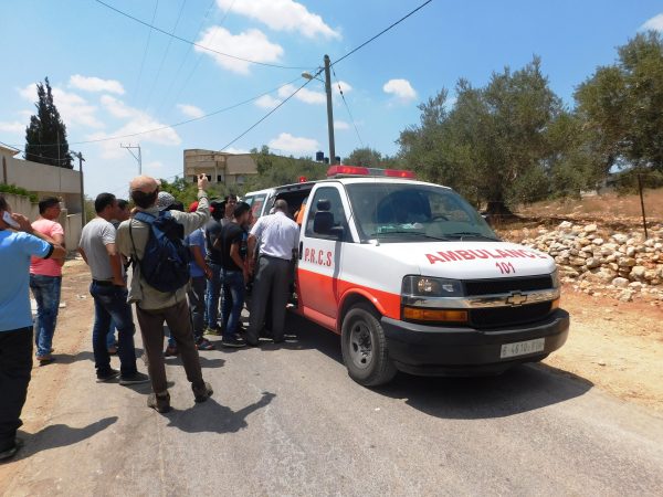 15-year old shot with live ammunition by Israeli forces loaded into ambulance