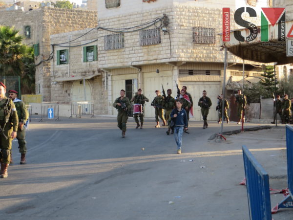 Soldiers marching through al-Khalil