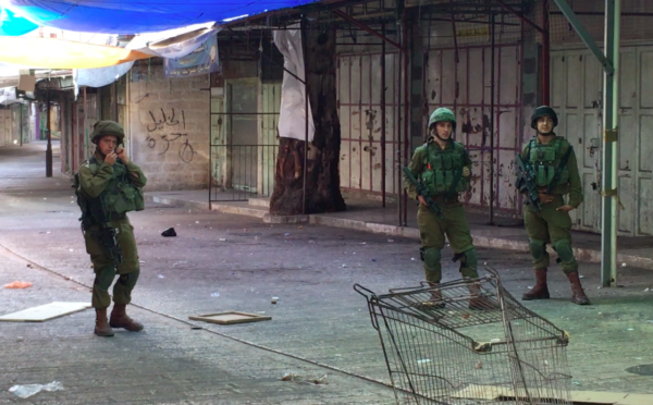 Occupying Israeli soldiers enter the Palestinian market in Al Khalil.