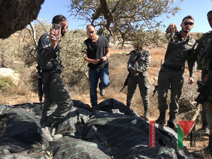 Israeli armed forces and settlers harassing farmers in As Sawiya