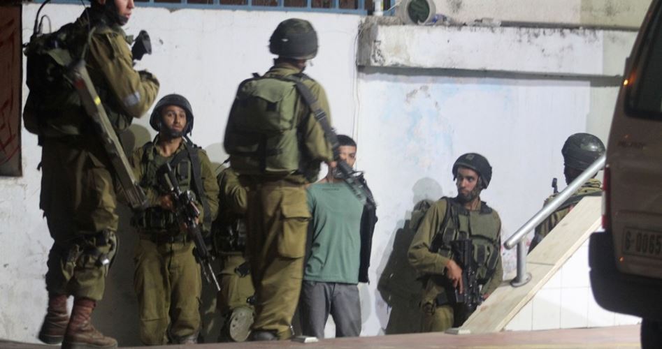 Young Palestinians being arrested by Israeli soldiers in Yabad