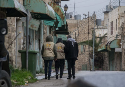 Two EAPPI members walk through Hebron with Palestinian man