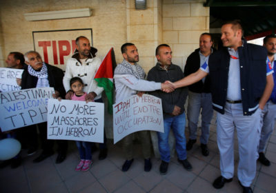 TIPH shakes hands with Palestinian man welcoming him to Hebron