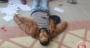 Yasser Fawzi Shweiki lies on the ground after being shot by the Israeli soldiers. Dozens of the court documents he was delivering can be seen scattered around his body.