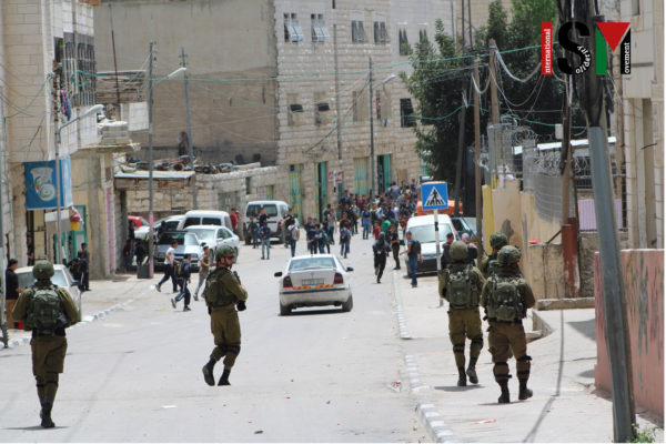 Soldiers, children in the background