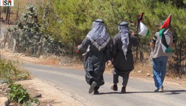 Villagers march to their spring in Qaryout