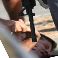 Police torturing Mohammed Mansour during his arrest in Ar-Ram June 2004